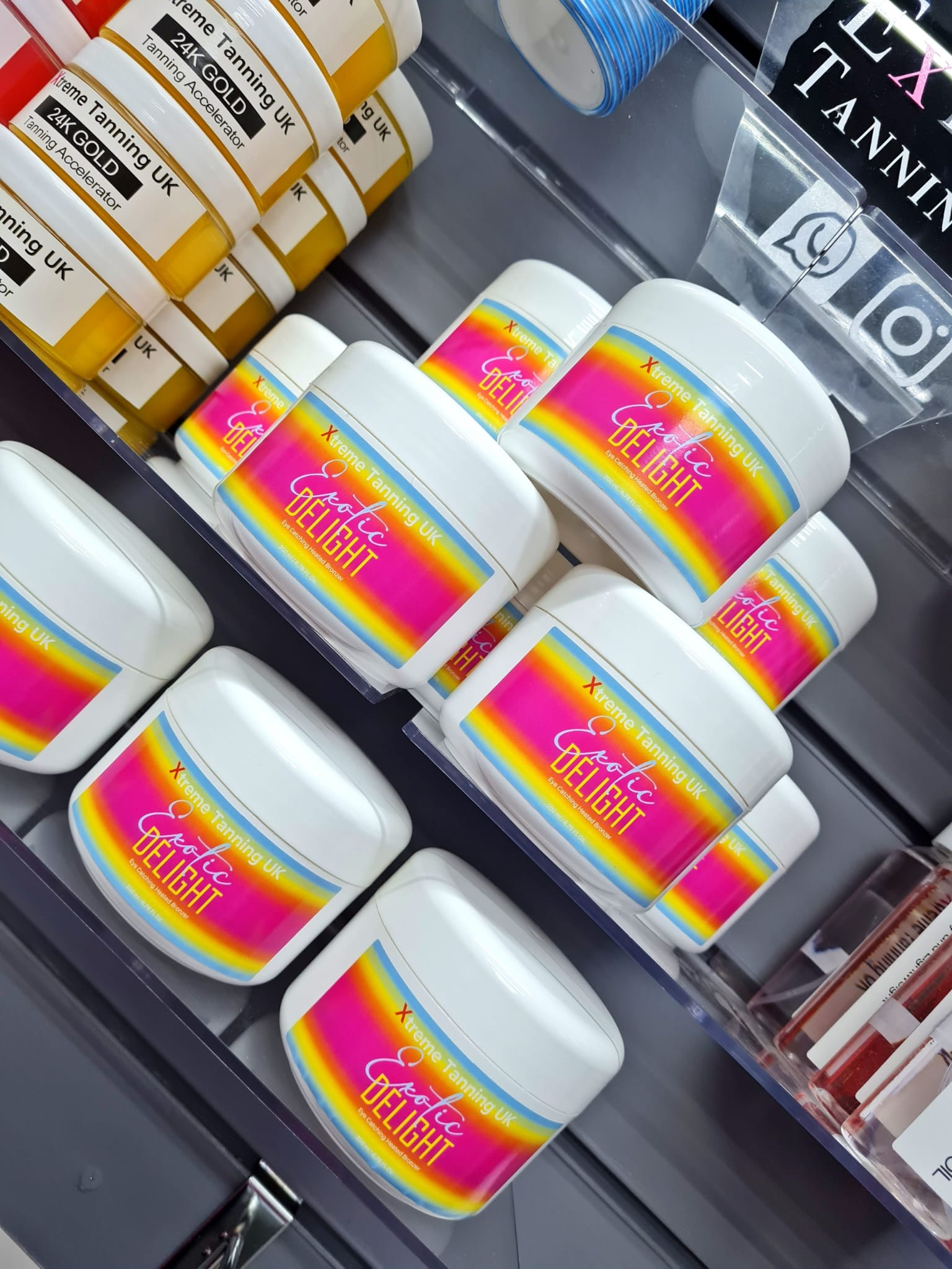 Colourful printed product labels applied to tanning accelerator tubs